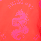 A close-up of a bright coral-orange fabric with a large hot pink graphic of a stylized fox and the words "TRIBE 627" printed above it.